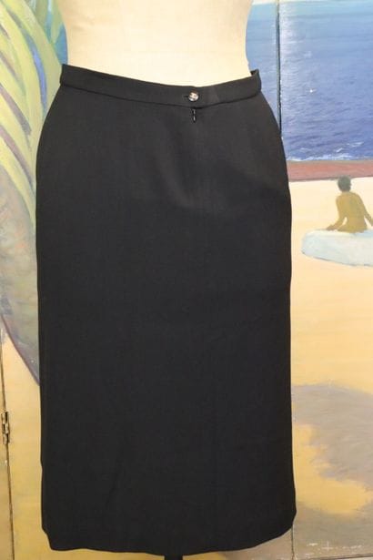 CHANEL. Meeting of two black wool skirts,...