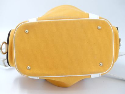 LANCEL. Orange canvas bucket bag with its...