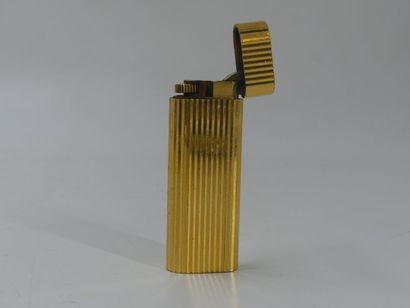 CARTIER. Lighter in gilded metal, signed...