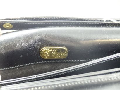 GUCCI. Black leather clutch bag, gold metal...