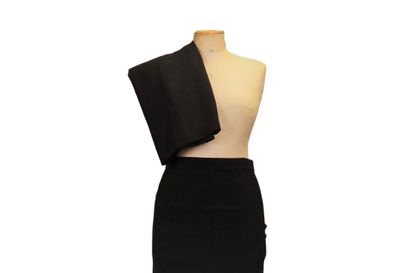 CHANEL. Meeting of two black wool skirts,...