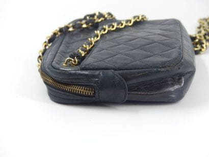 CHANEL. Small quilted camera bag in navy...