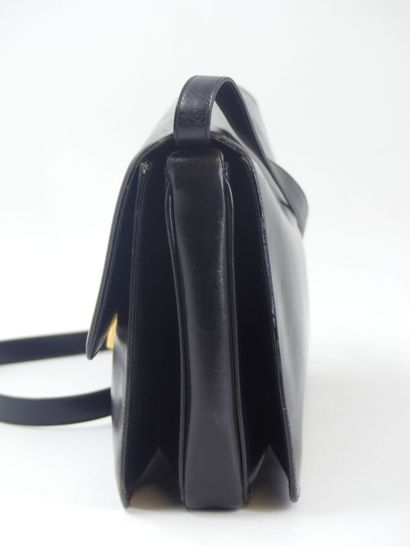 GUCCI. Black leather clutch bag, gold metal...
