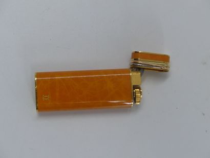 CARTIER. Lighter in orange lacquer and gold...