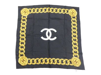 CHANEL. Silk square with gold chain decoration...