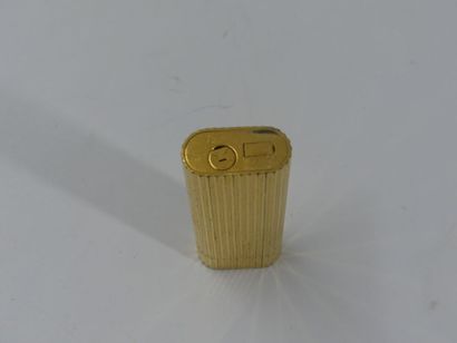CARTIER. Lighter in gilded metal, signed...