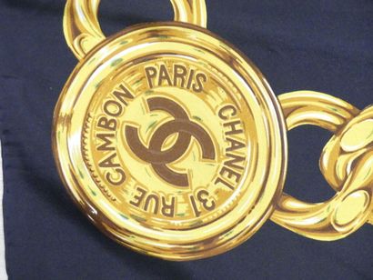 CHANEL. Silk square with gold chain decoration...