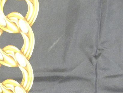 CHANEL. Silk square with gold chain decoration...