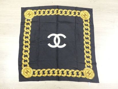 CHANEL. Silk square with gold chain decoration...