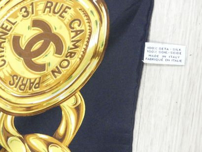 CHANEL. Silk square with gold chain decoration...
