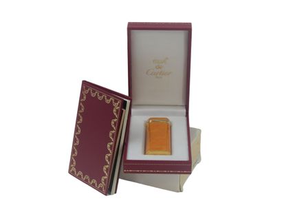 CARTIER. Lighter in orange lacquer and gold...