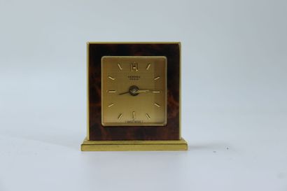 HERMES. Travel alarm clock in gilt metal...