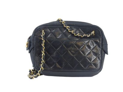 CHANEL. Small quilted camera bag in navy...