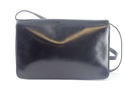 GUCCI. Black leather clutch bag, gold metal...