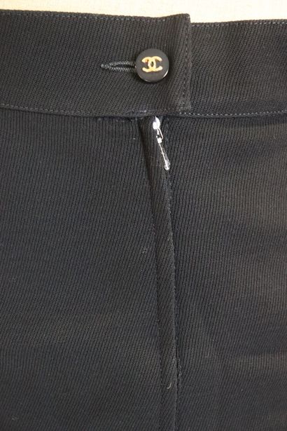 CHANEL. Meeting of two black wool skirts,...