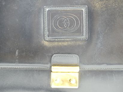 GUCCI. Black leather clutch bag, gold metal...