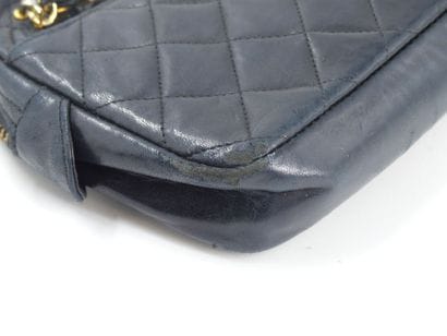 CHANEL. Small quilted camera bag in navy...