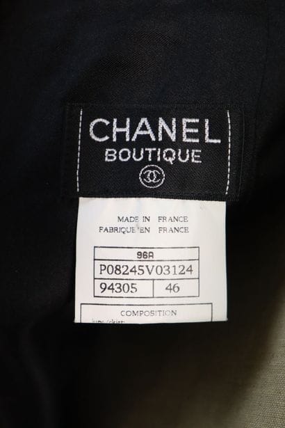 CHANEL. Meeting of two black wool skirts,...