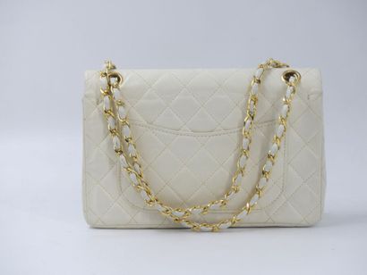CHANEL. Classic quilted bag in white lambskin,...