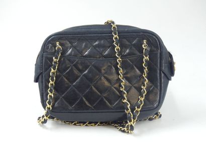 CHANEL. Small quilted camera bag in navy...