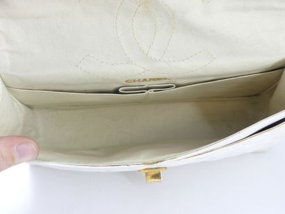 CHANEL. Classic quilted bag in white lambskin,...