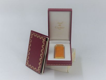 CARTIER. Lighter in orange lacquer and gold...