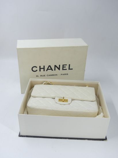 CHANEL. Classic quilted bag in white lambskin,...