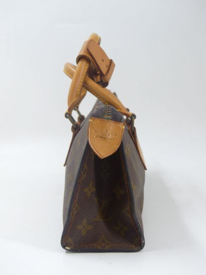 LOUIS VUITTON. Triangular bag in monogram...
