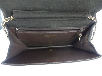 CHANEL. Brown jersey clutch bag, chain handle...