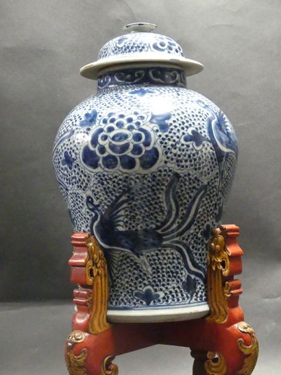 Asia, vase in blue white resting on a wooden...