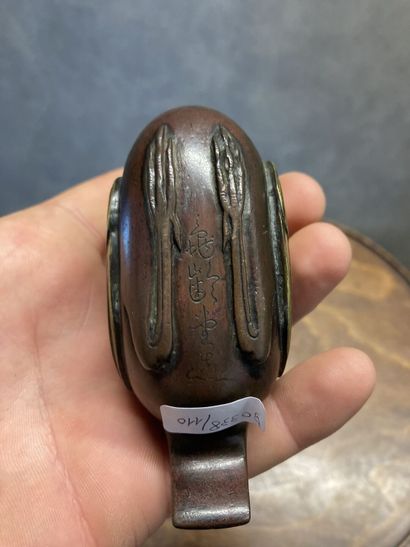 TIBET
Bronze kohl bottle with brown and gilt...