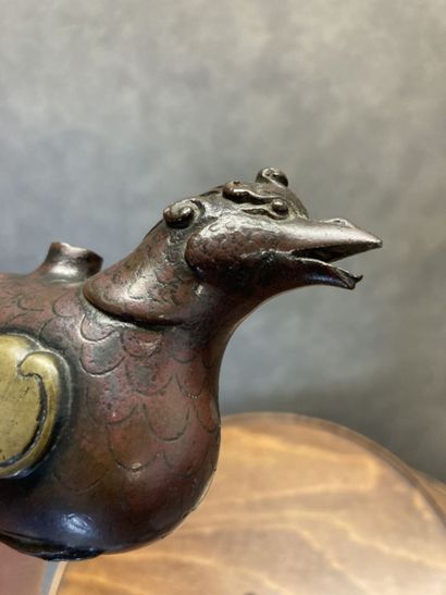 TIBET
Bronze kohl bottle with brown and gilt...
