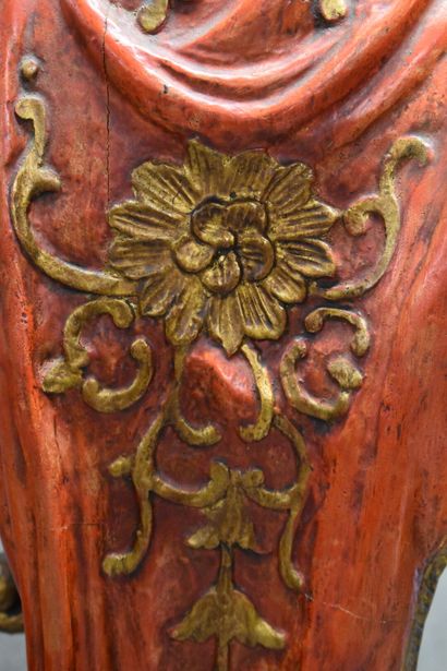 Man with a cape carrying a torch in carved...