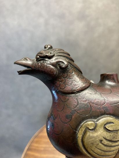 TIBET
Bronze kohl bottle with brown and gilt...