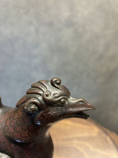 TIBET
Bronze kohl bottle with brown and gilt...