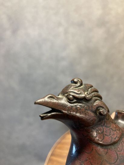 TIBET
Bronze kohl bottle with brown and gilt...
