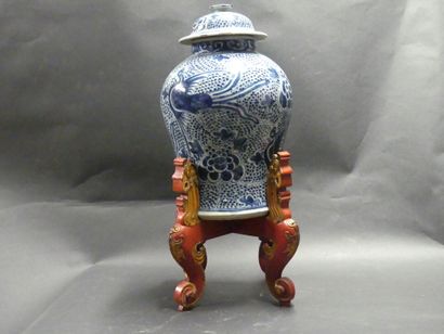 Asia, vase in blue white resting on a wooden...