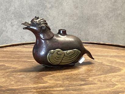 TIBET
Bronze kohl bottle with brown and gilt...