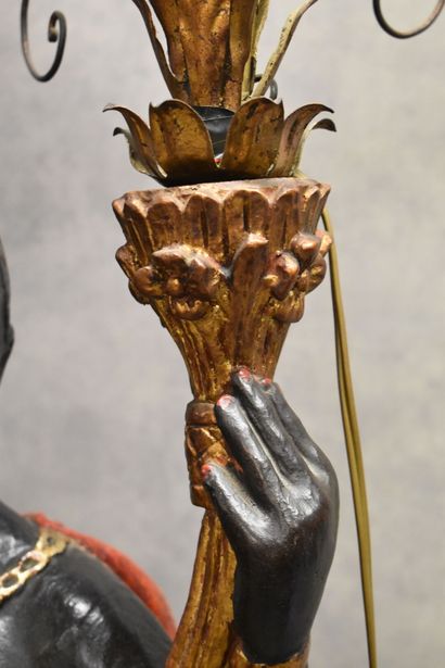 Man with a cape carrying a torch in carved...