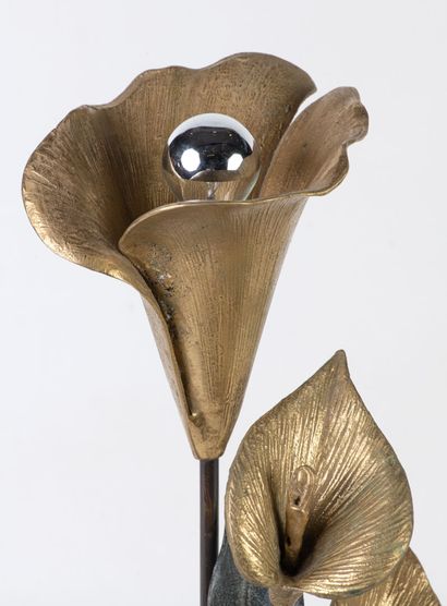 Table lamp featuring a flowering plant, part...
