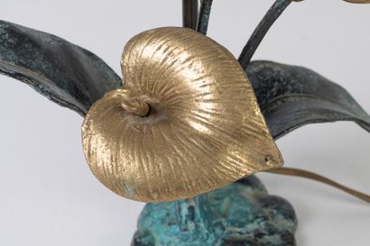 Table lamp featuring a flowering plant, part...