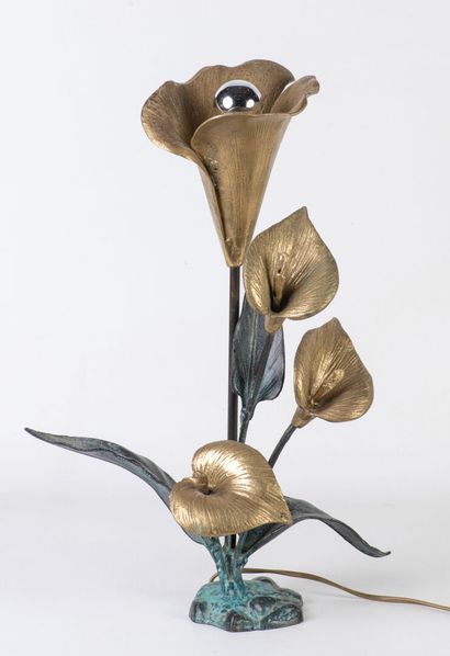 Table lamp featuring a flowering plant, part...