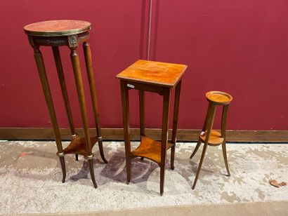 A set of three sellettes, including a tall...