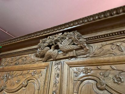 A Norman cabinet in blond oak with a bouquet...