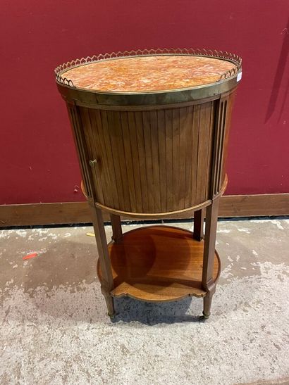 A circular bedside table, marble top, brass...
