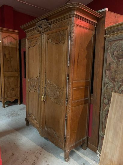 A Norman cabinet in blond oak with a bouquet...