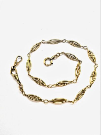 CHAINE giletière en or jaune 18K (750/°°),...