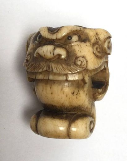 Deer antlers carved in the shape of a lion's...