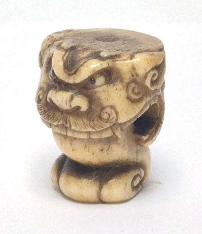Deer antlers carved in the shape of a lion's...