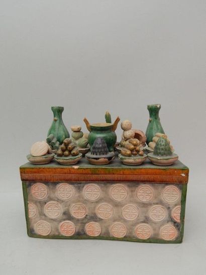 Table with fifteen glazed terracotta offerings....